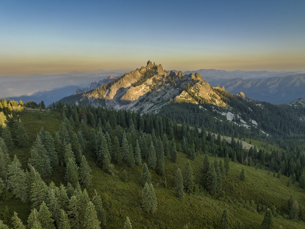 a view of a mountain range with trees in the foreground