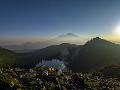 Sunrise view over Mount Rinjani from the Sembalun trail with trekkers preparing their gear.