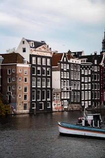 A peaceful canal in Amsterdam with traditional Dutch houses reflecting in the water.