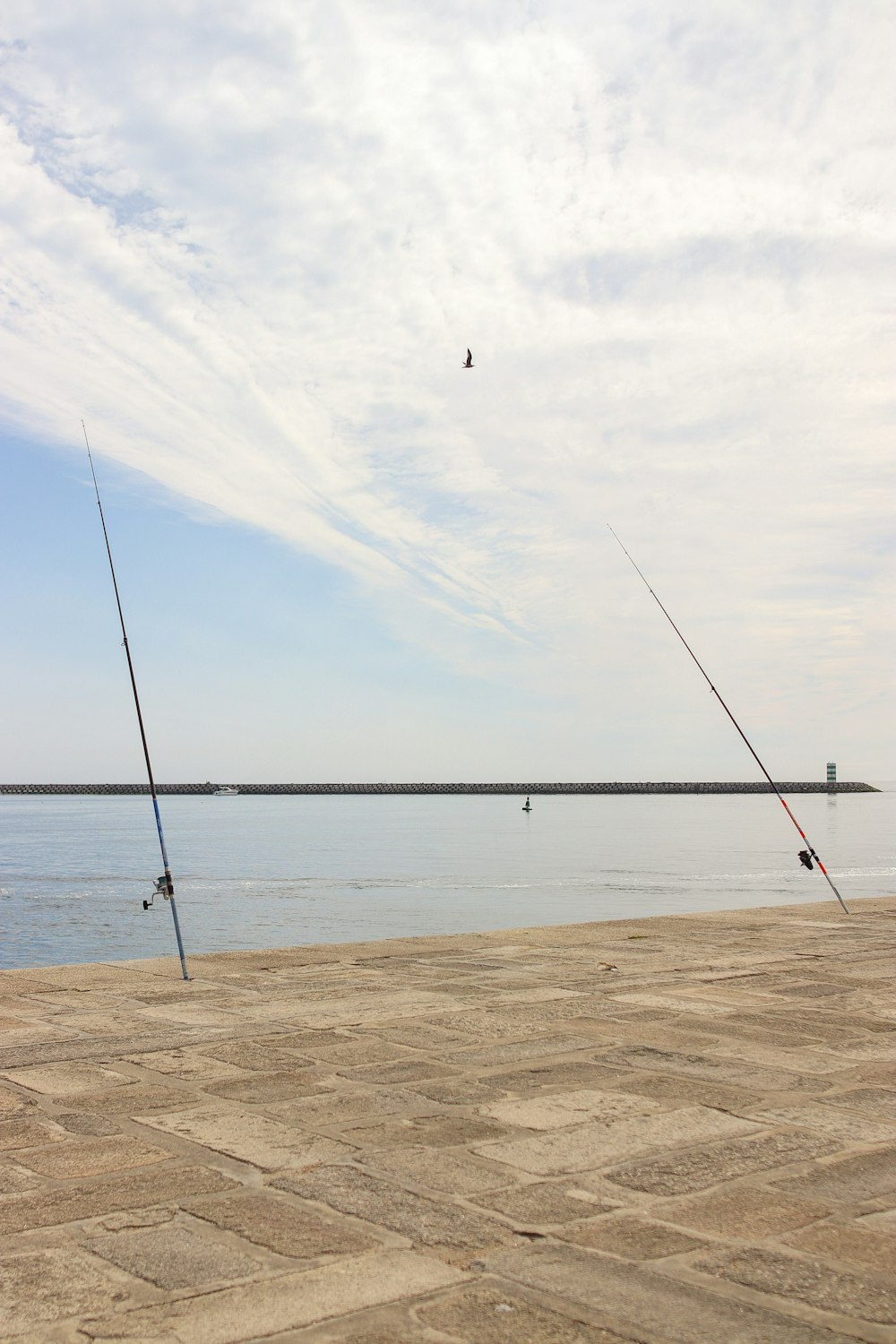 a couple of fishing rods sitting on top of a pier