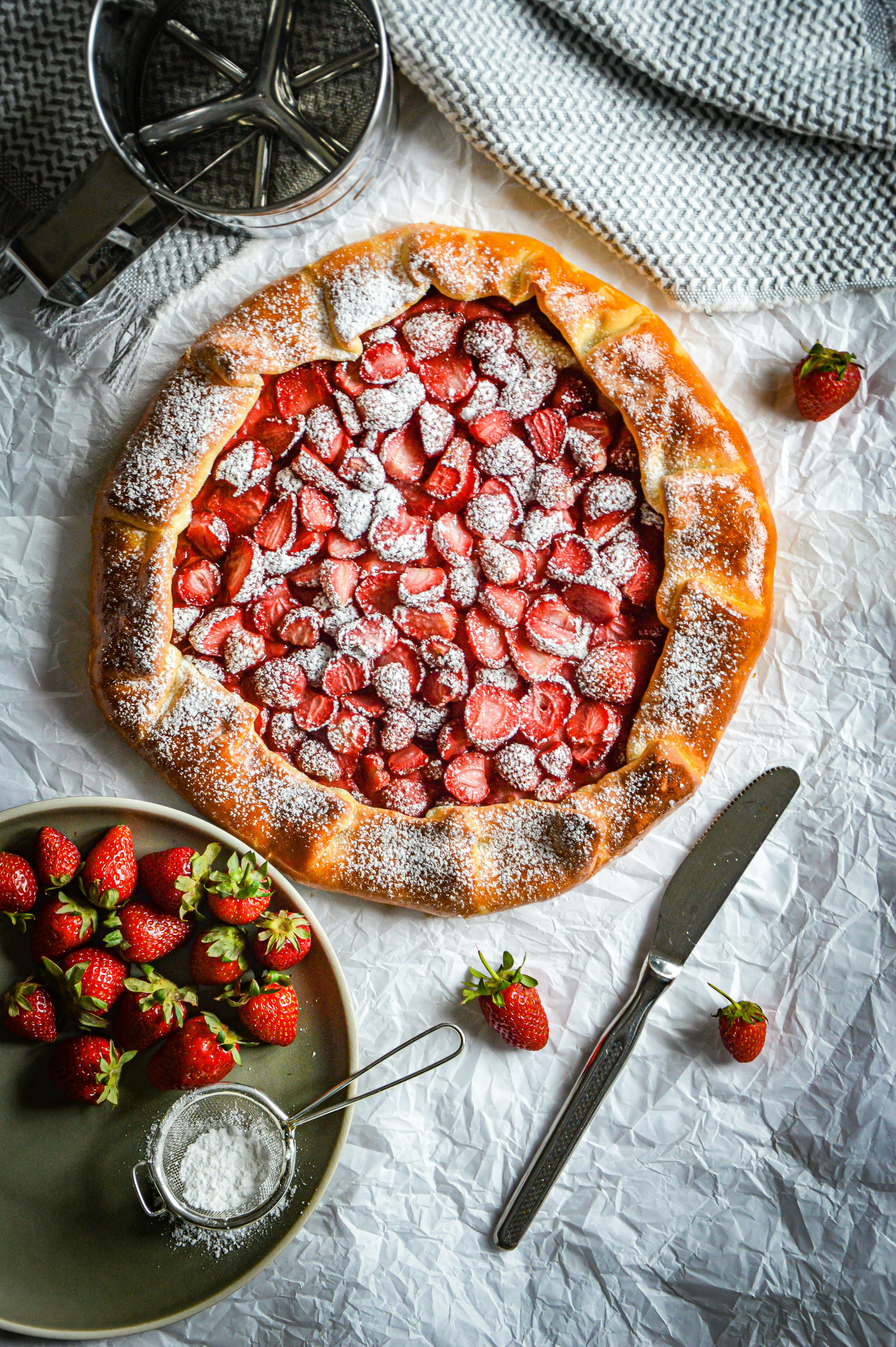 a dessert with strawberries and powdered sugar on top