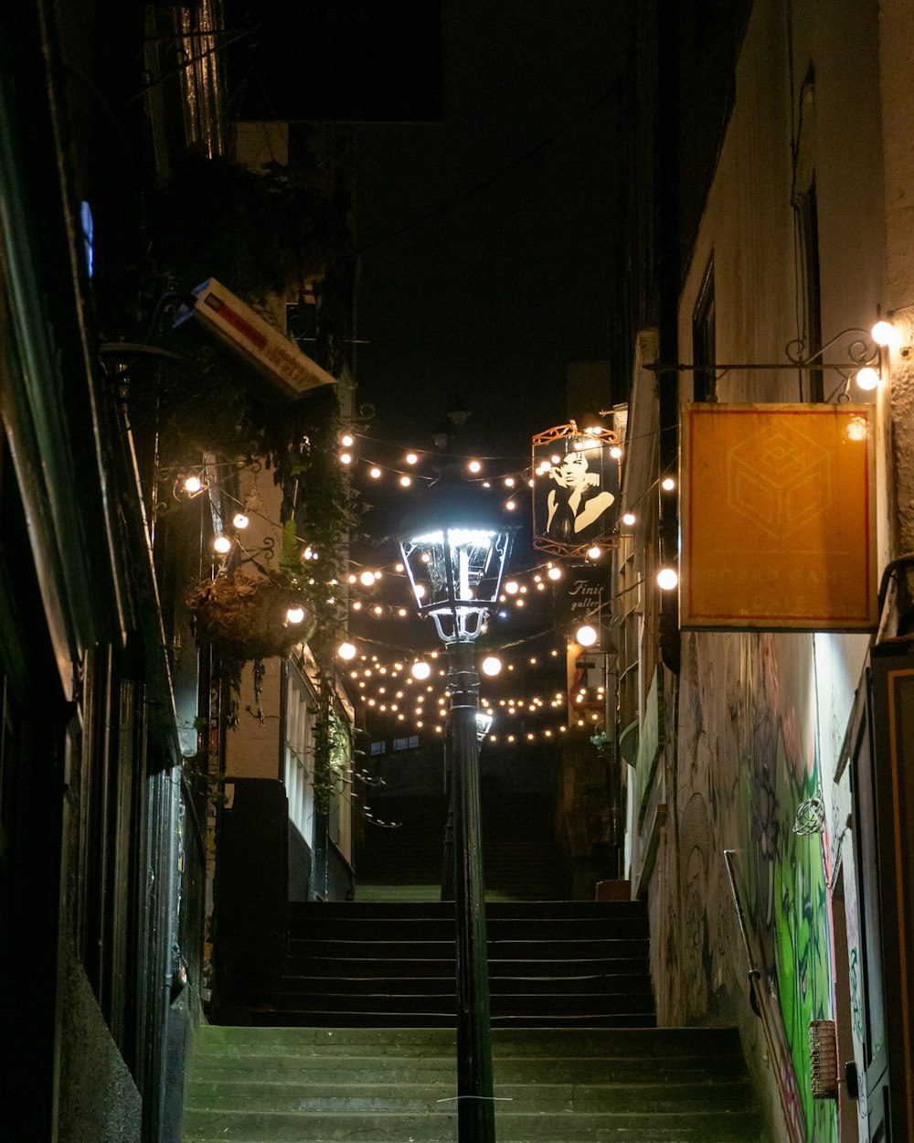 a stairway with lights and a basketball hoop