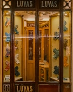 Display of various safety gloves and protective gear on a store shelf.