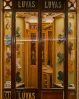 Rows of neatly arranged ceremonial gloves in different sizes and styles.