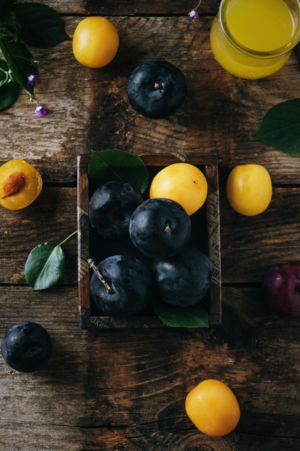 a wooden box filled with blueberries and oranges