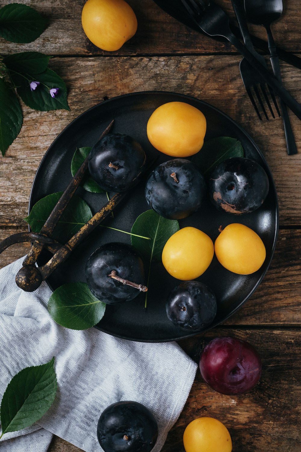 a plate of fruit on a wooden table