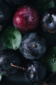 a bowl filled with blueberries and cherries covered in water