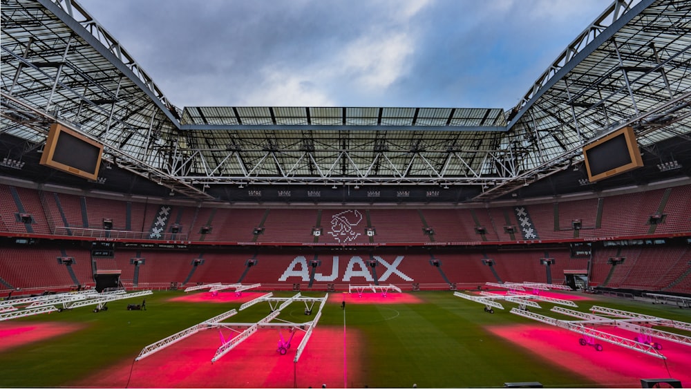 the inside of a stadium with a red field