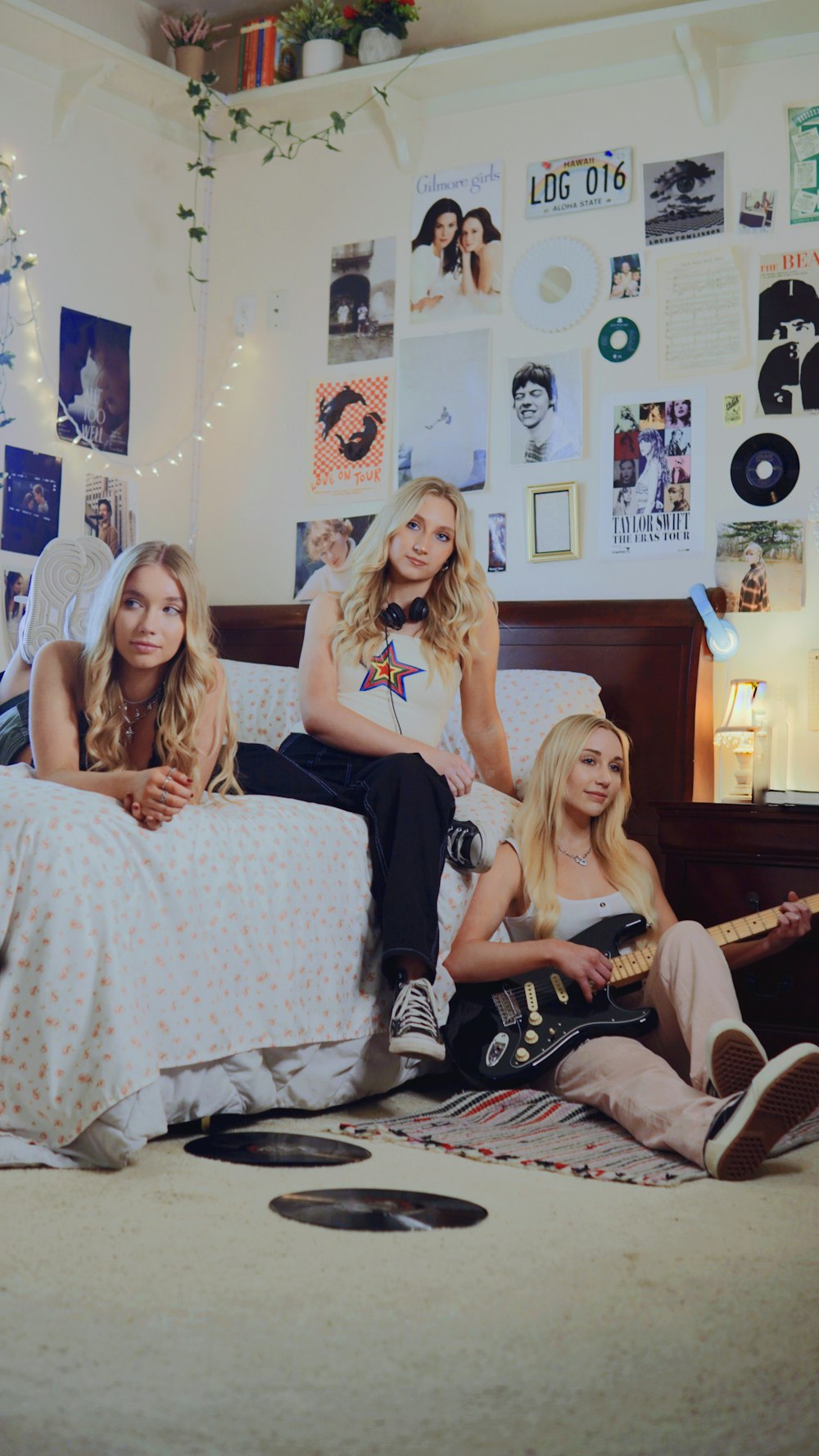 a group of women sitting on top of a bed