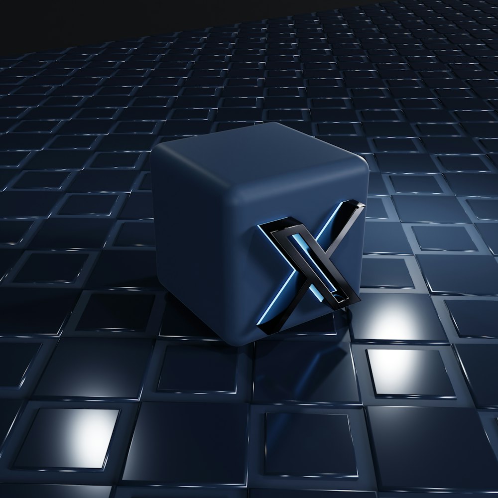 Un cubo azul sentado encima de un piso de baldosas