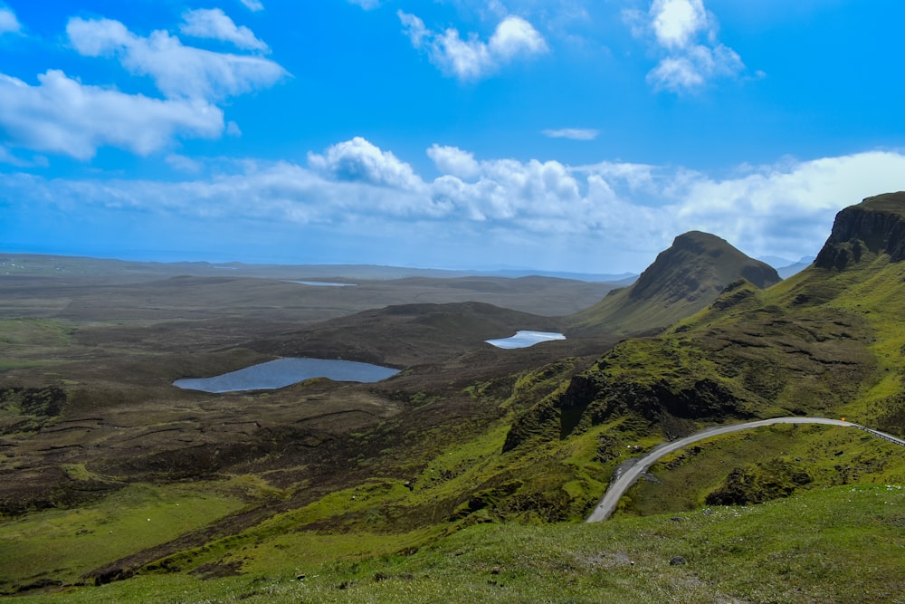 a scenic view of a winding road in the mountains