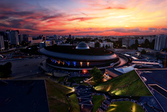 an aerial view of a building with a sunset in the background