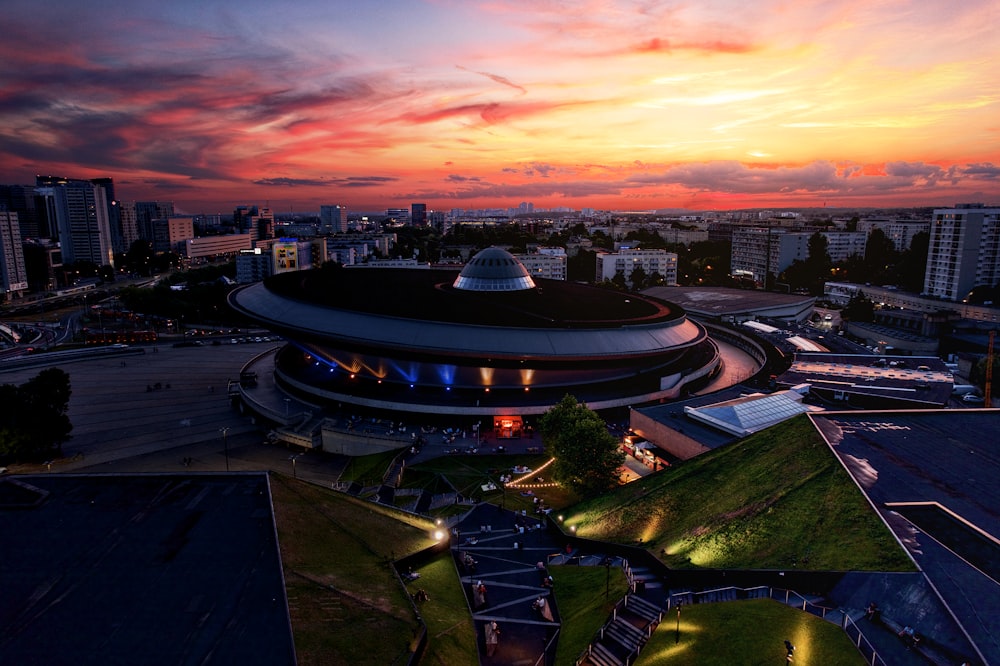 an aerial view of a building with a sunset in the background