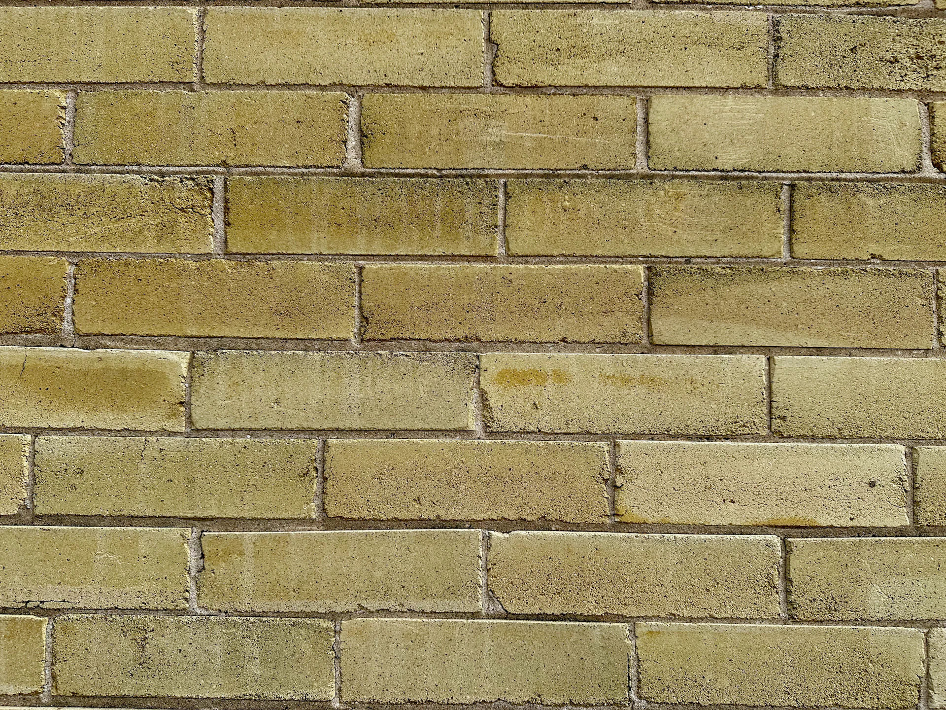 a close up of a yellow brick wall