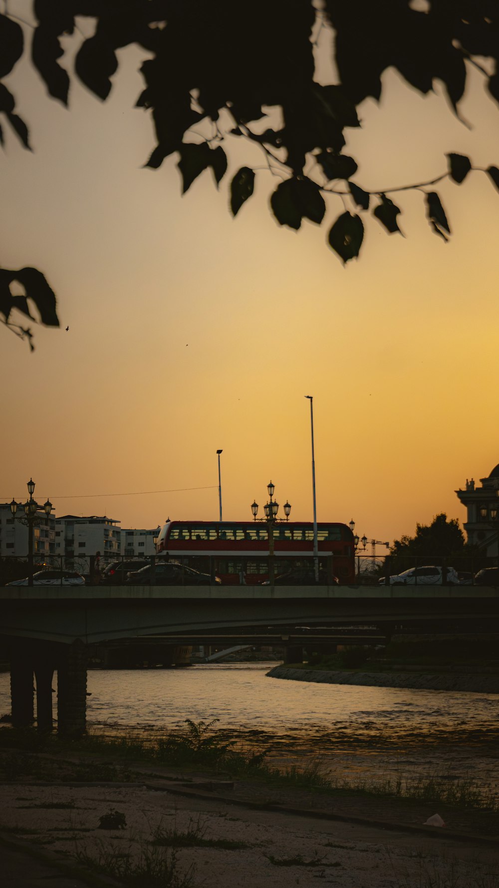 a train traveling over a bridge at sunset