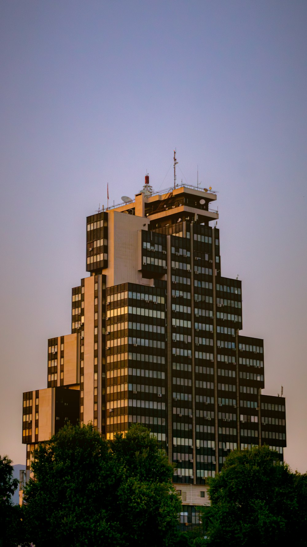 a tall building with a crane on top of it