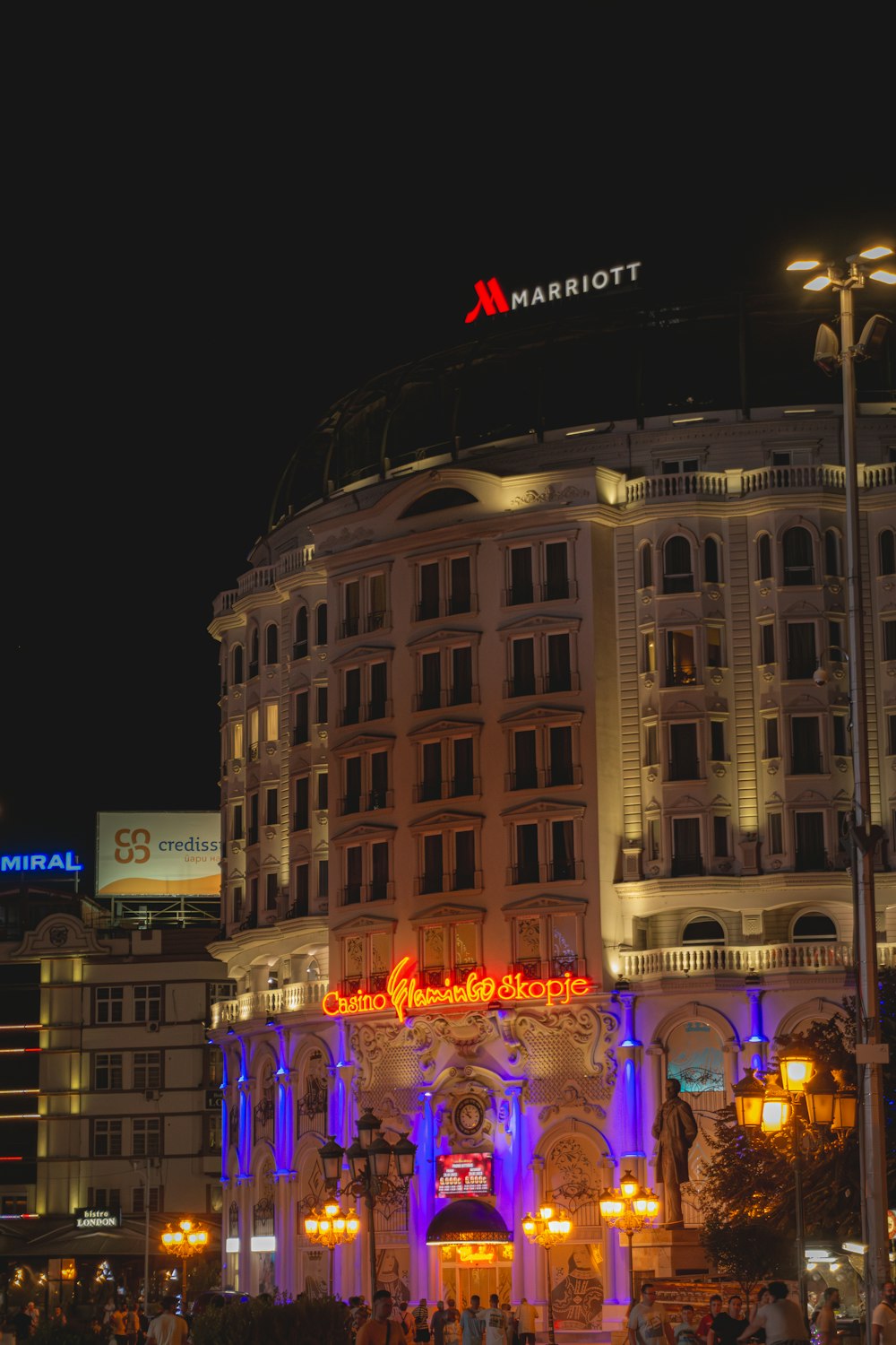 a large building with a lit up sign on top of it