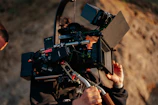 Behind-the-scenes shot of the crew setting up a complex camera rig outdoors.
