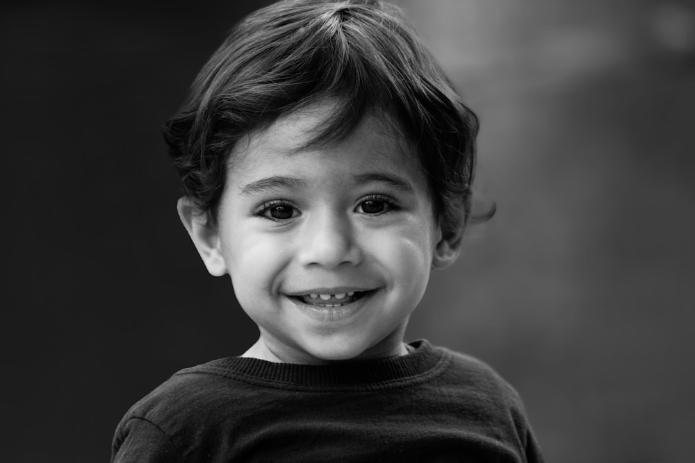 a black and white photo of a young boy