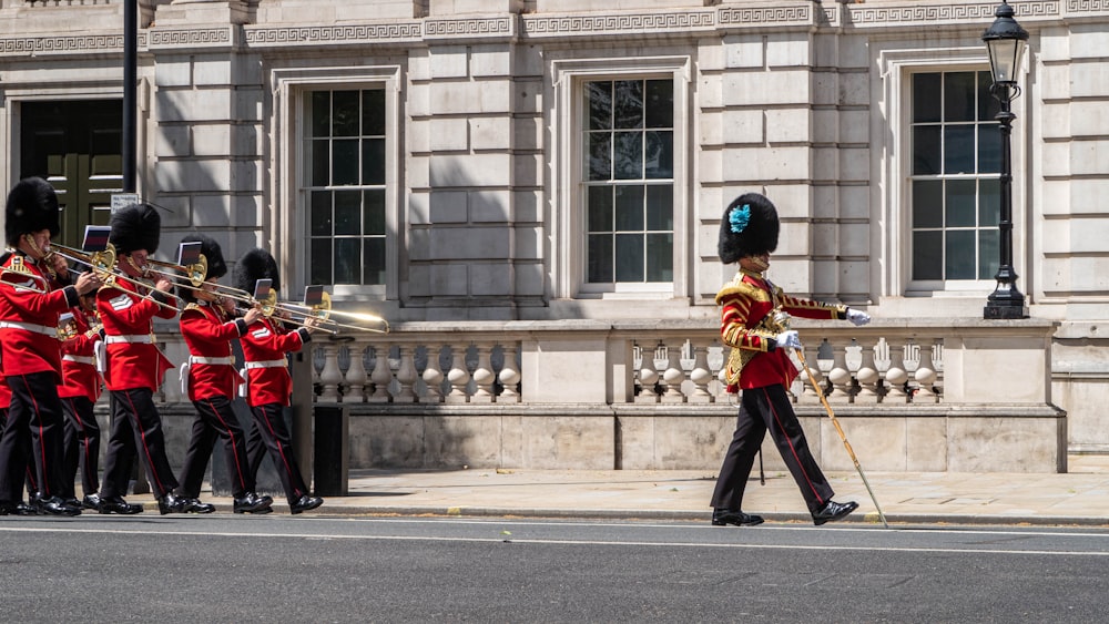 a group of men in uniform marching down a street