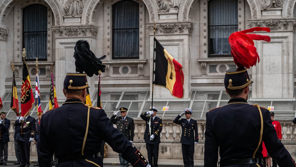 a group of men in uniform standing in front of a building