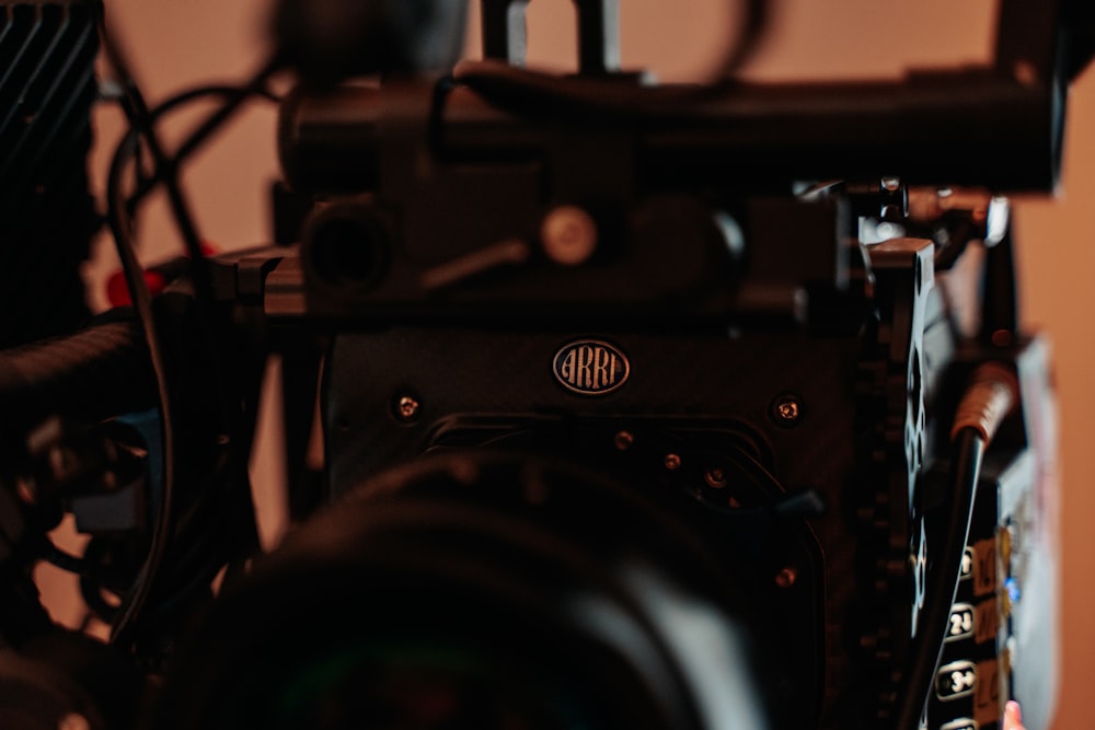 a close up of a camera with a hand on it