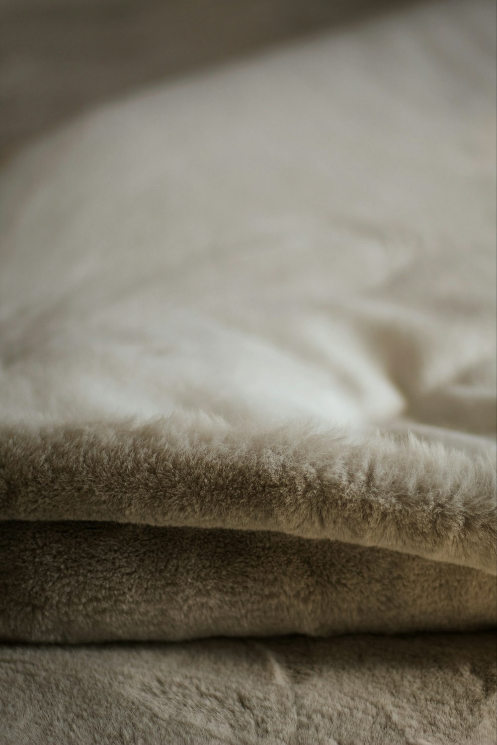 a close up of a blanket on a bed