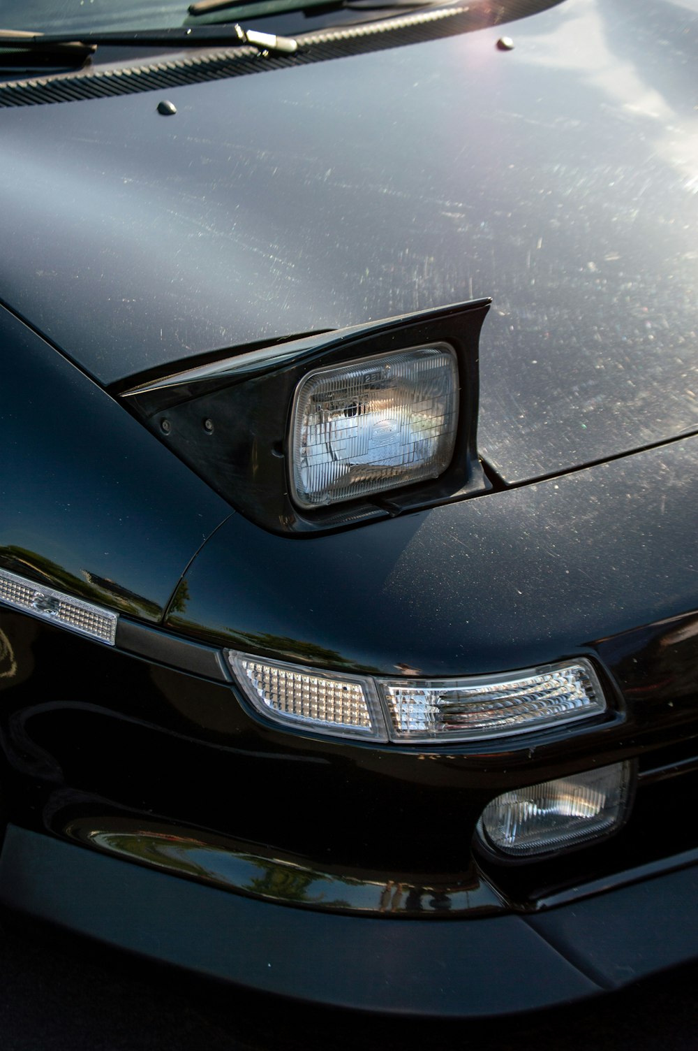 a close up of the front of a black sports car