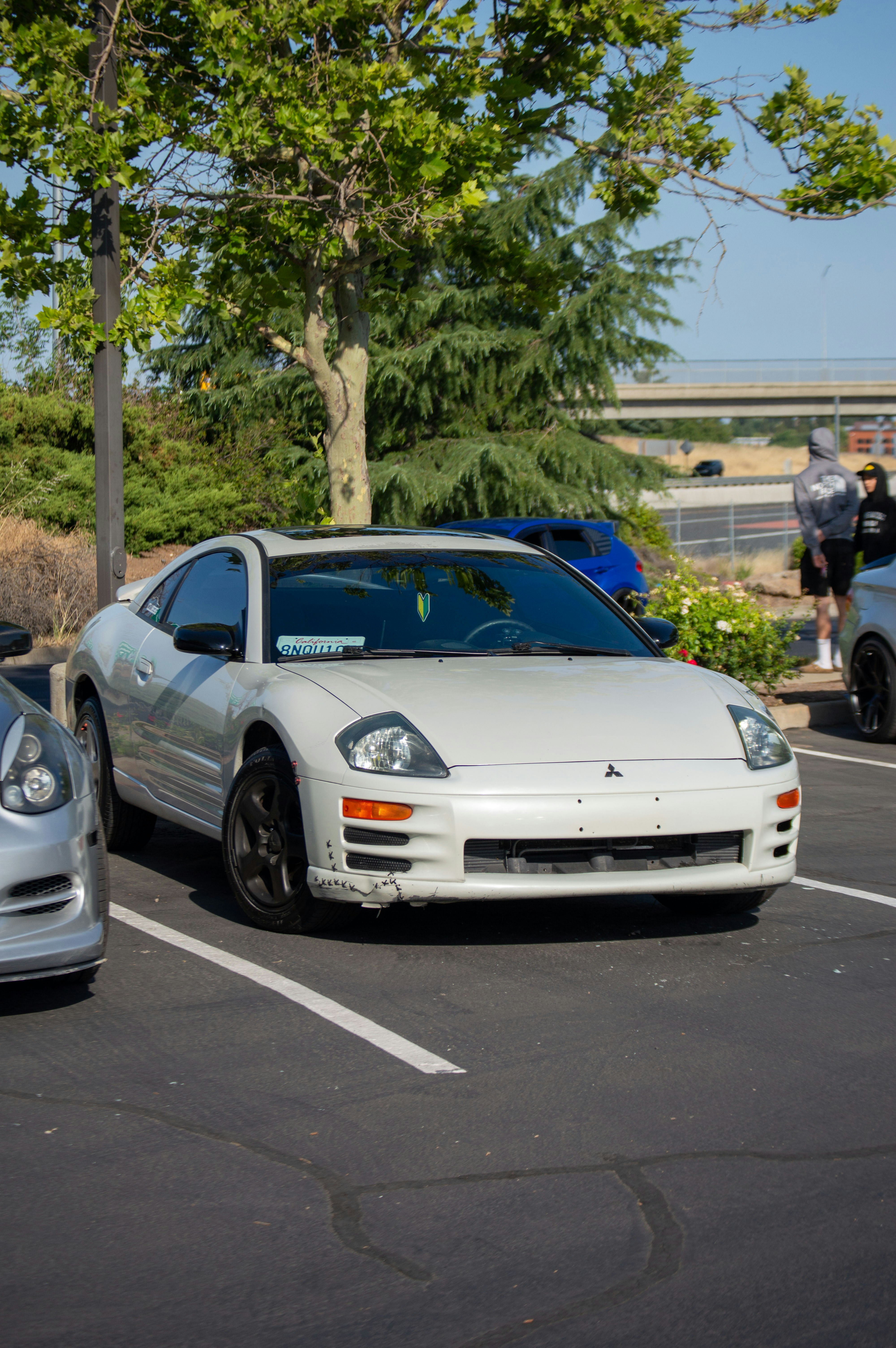 two cars parked in a parking lot next to each other