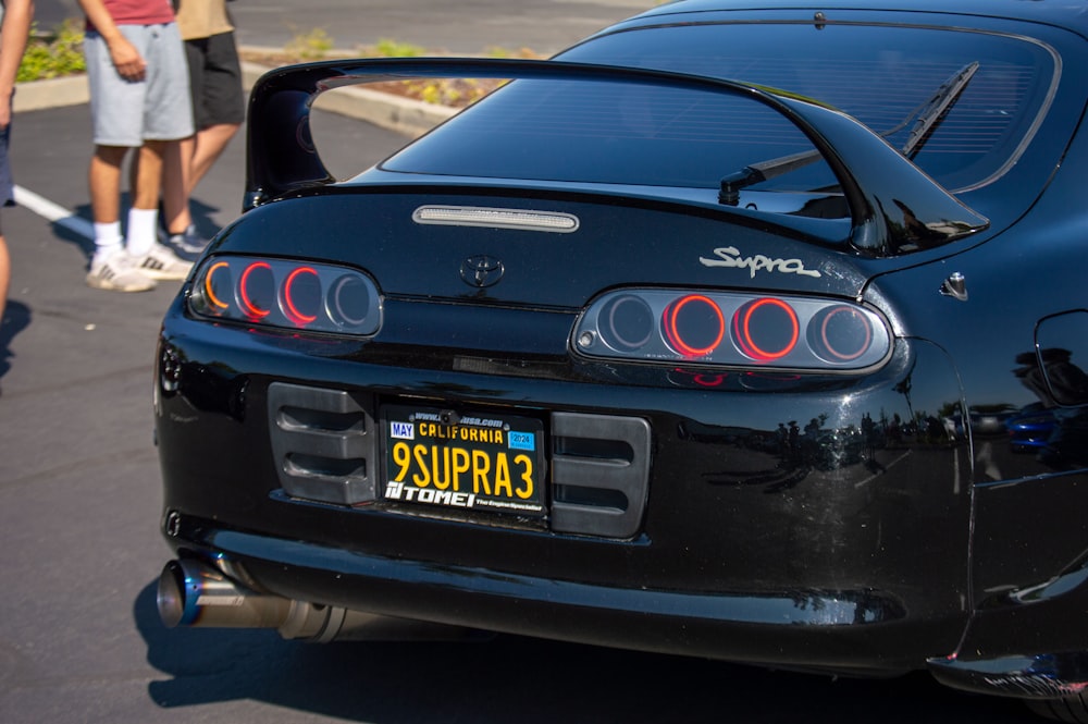 a black sports car parked on the side of the road