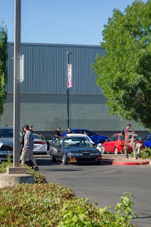 A team of experts working on multiple cars in a corporate parking lot.