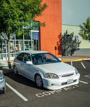 A compact car parked in an airport setting.