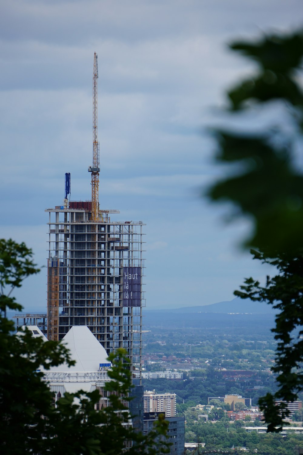 a tall building under construction with a sky background