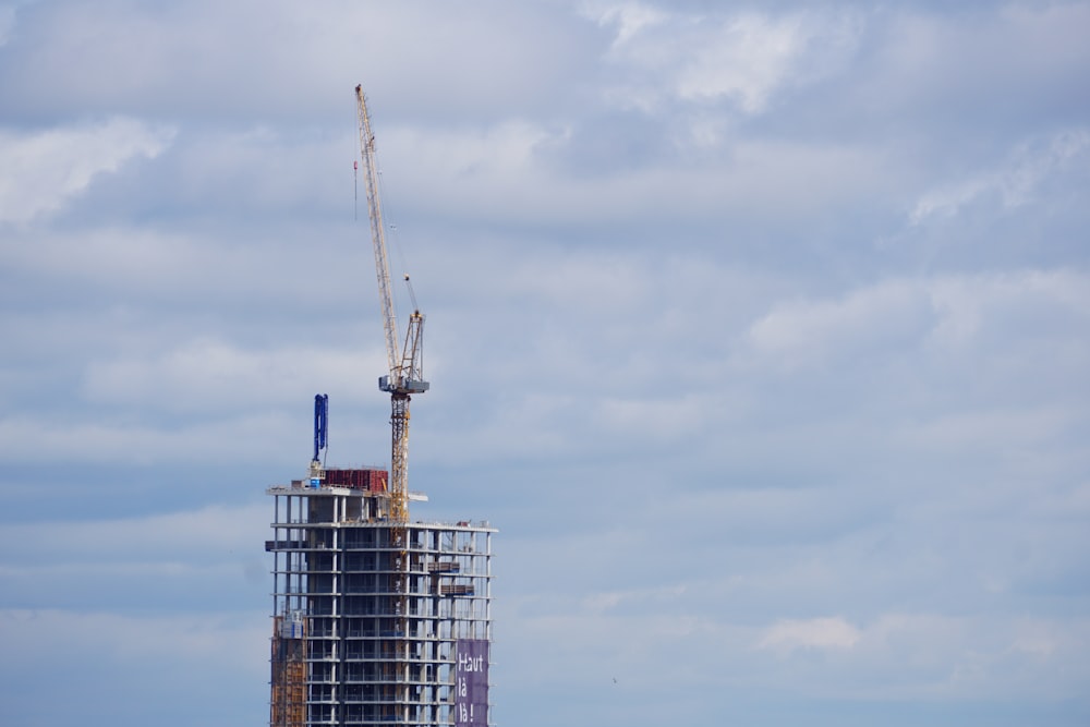 a tall tower with a crane on top of it