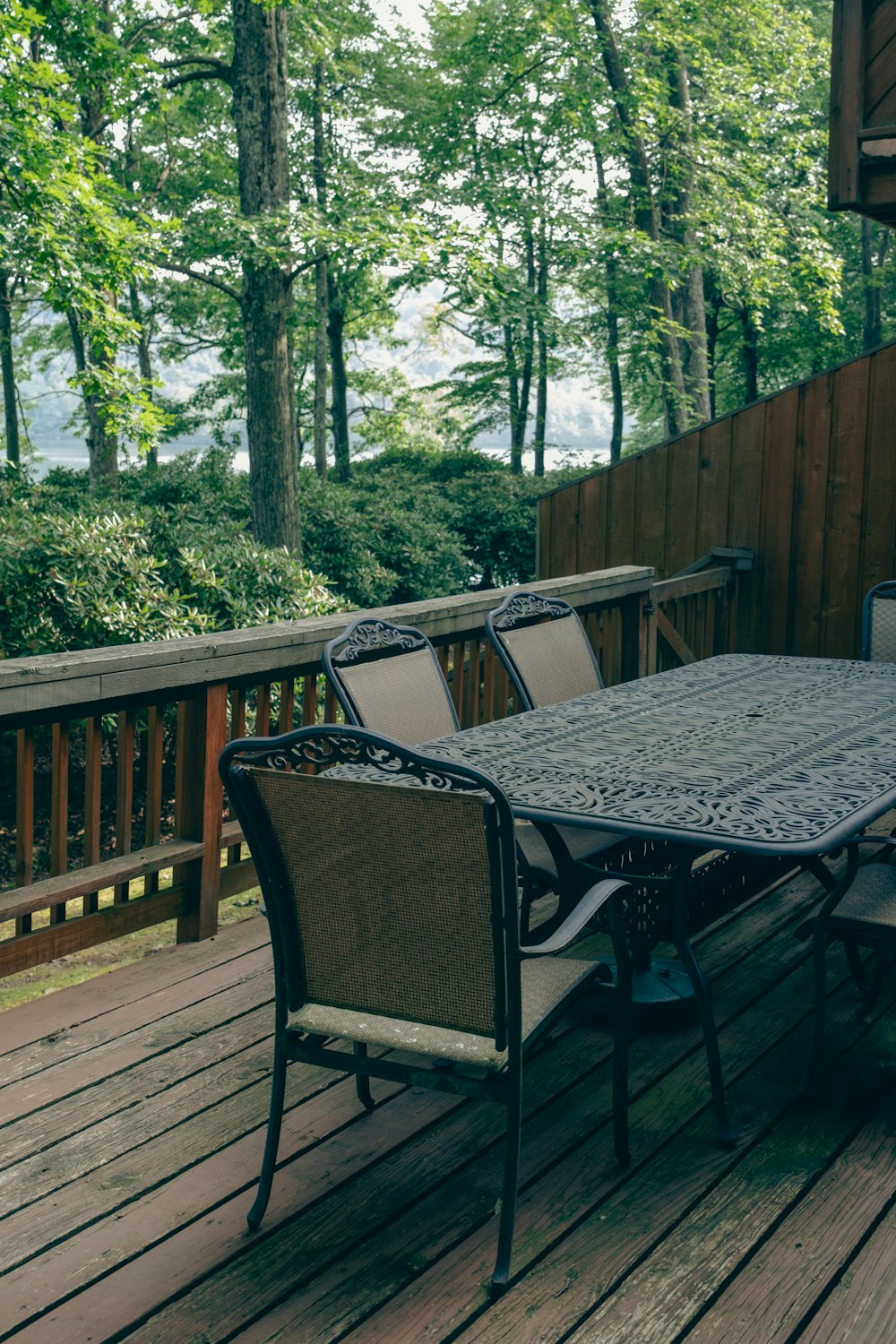 a table and chairs on a wooden deck