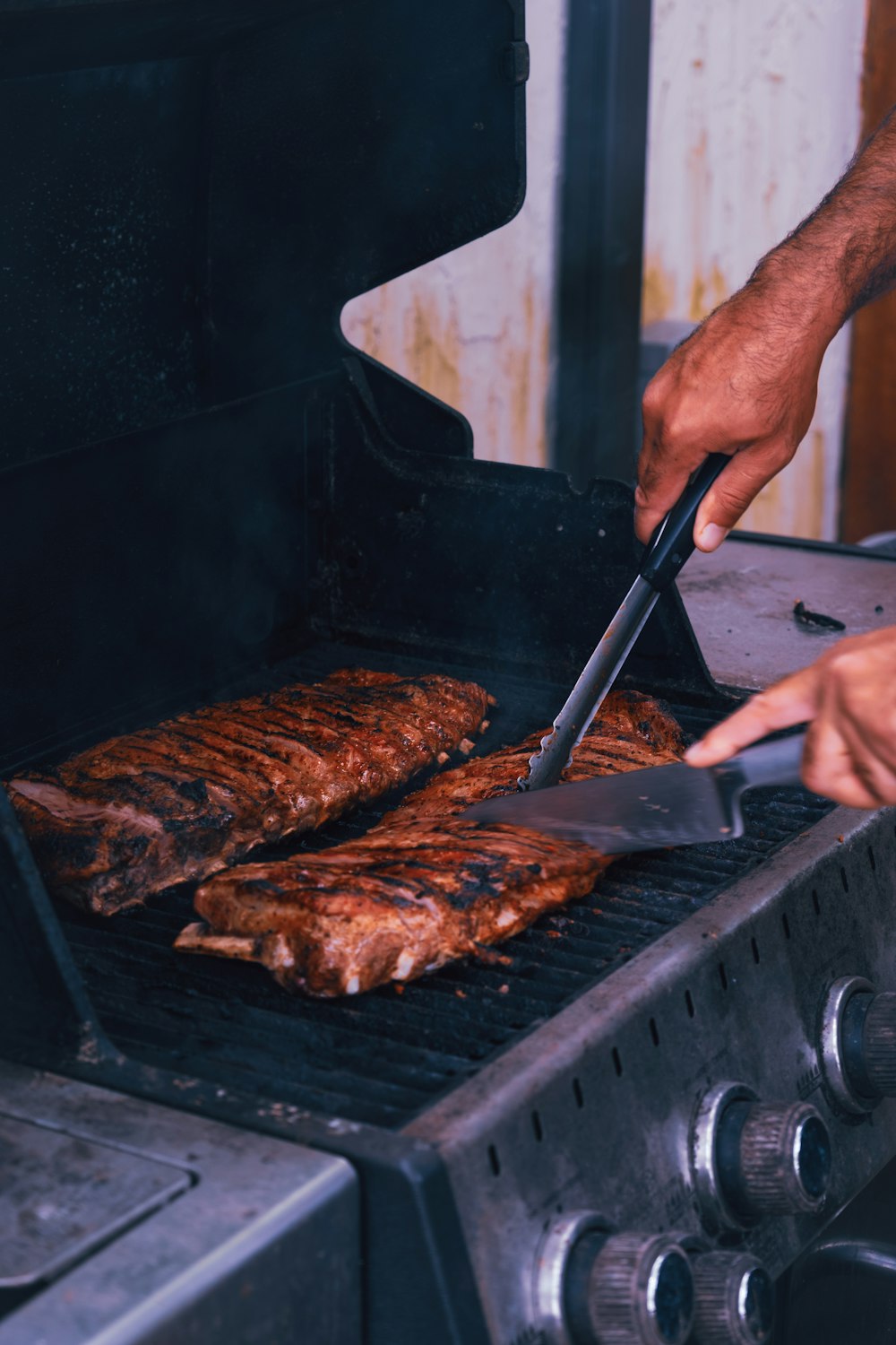 a man is grilling some meat on a grill