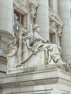 a statue of a woman sitting on top of a building