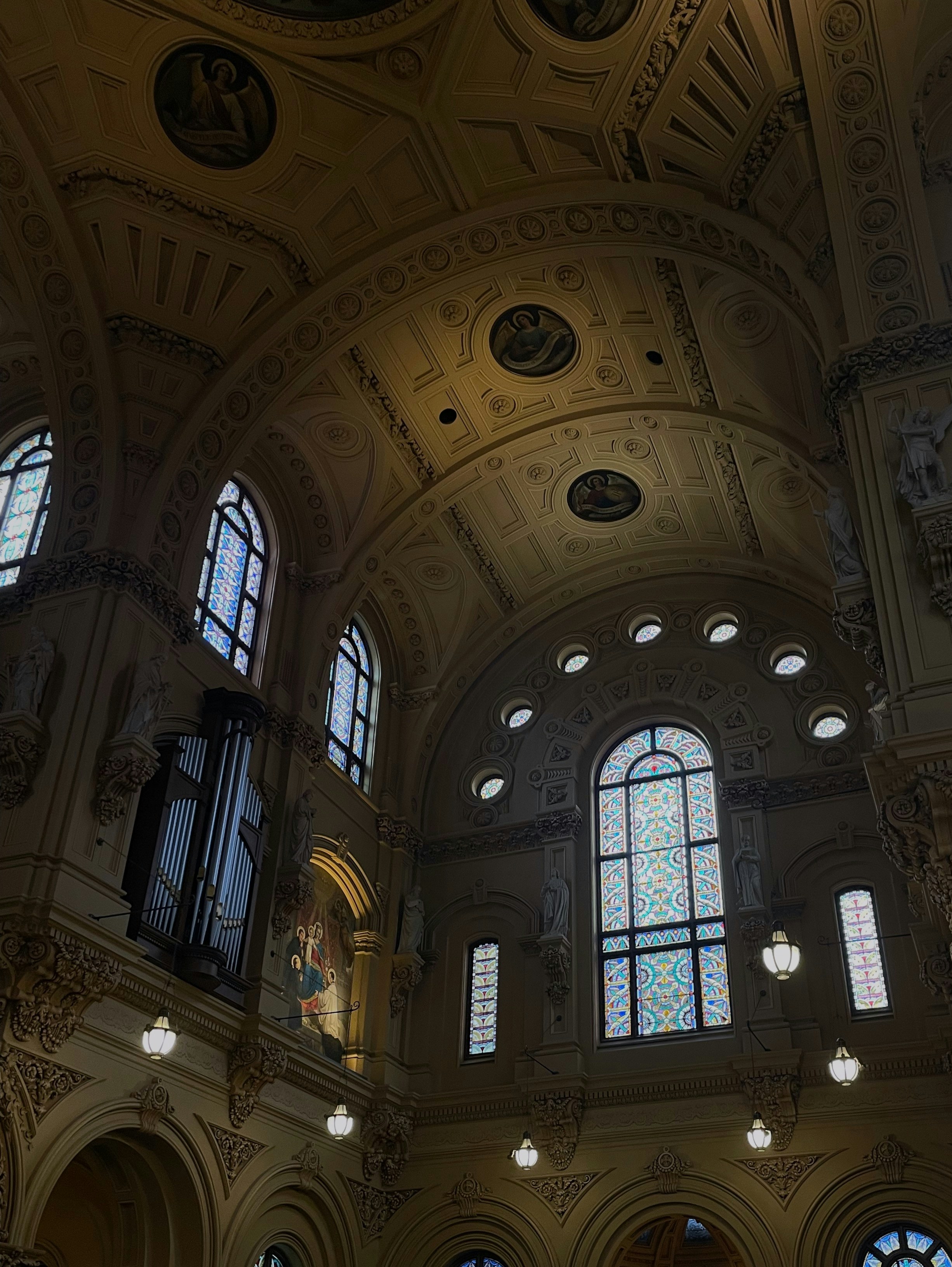 the ceiling of a large building with many windows