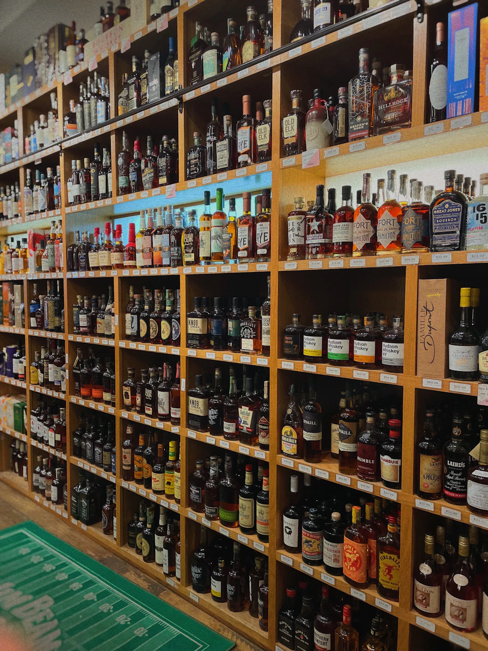 Liquor store shelves stocked with bottles of spirits and wine