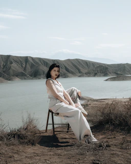 Portrait of an author sitting quietly in a natural Patagonian landscape with muted earth tones