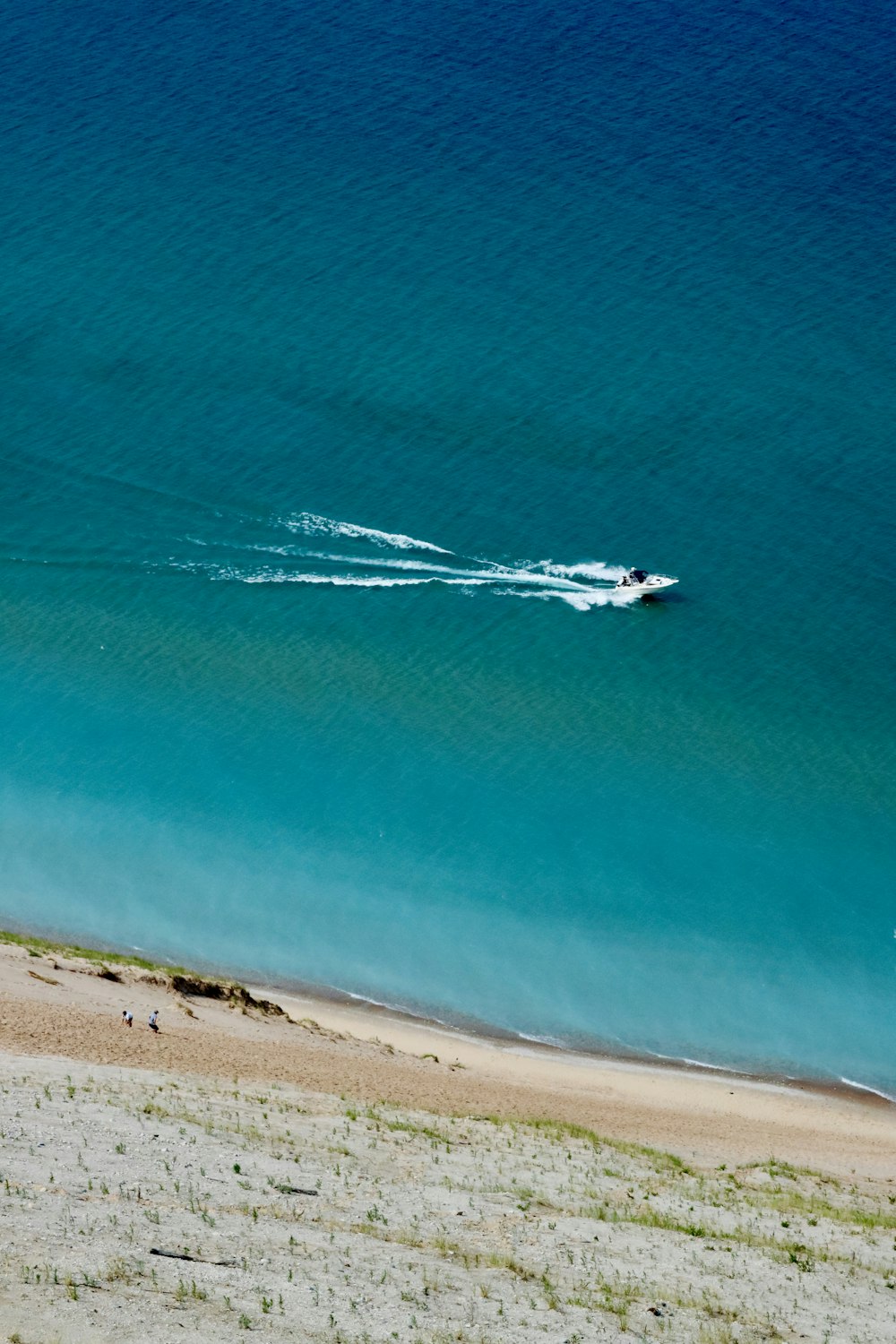 a boat is out on the water near the beach