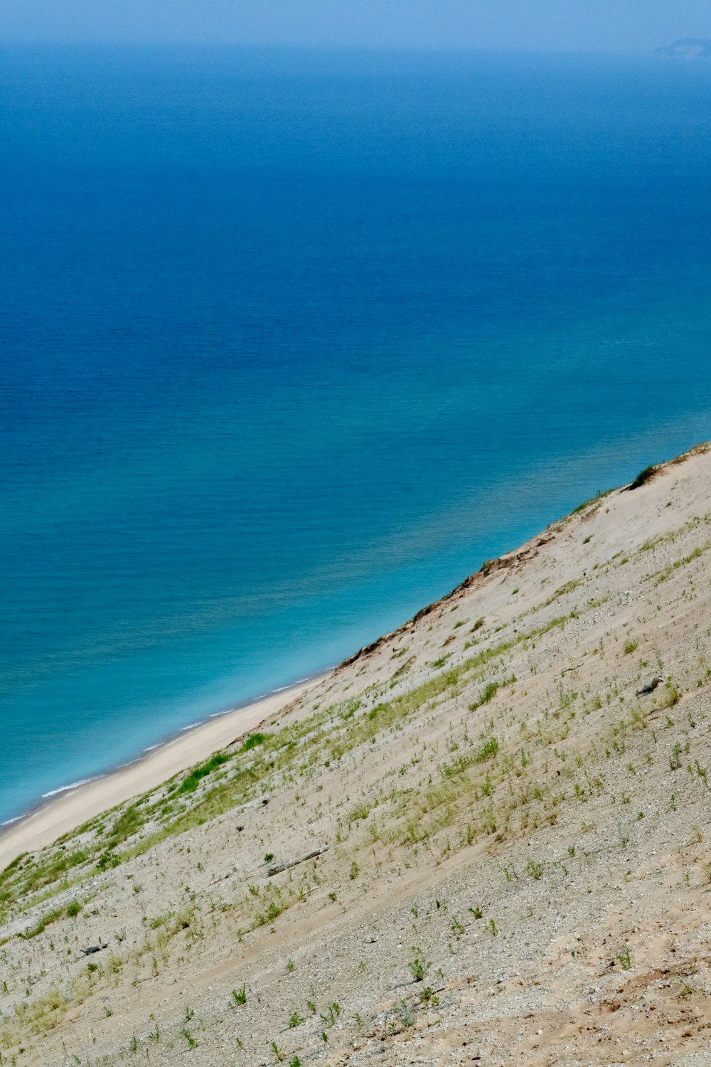 a man riding a horse on top of a sandy hill