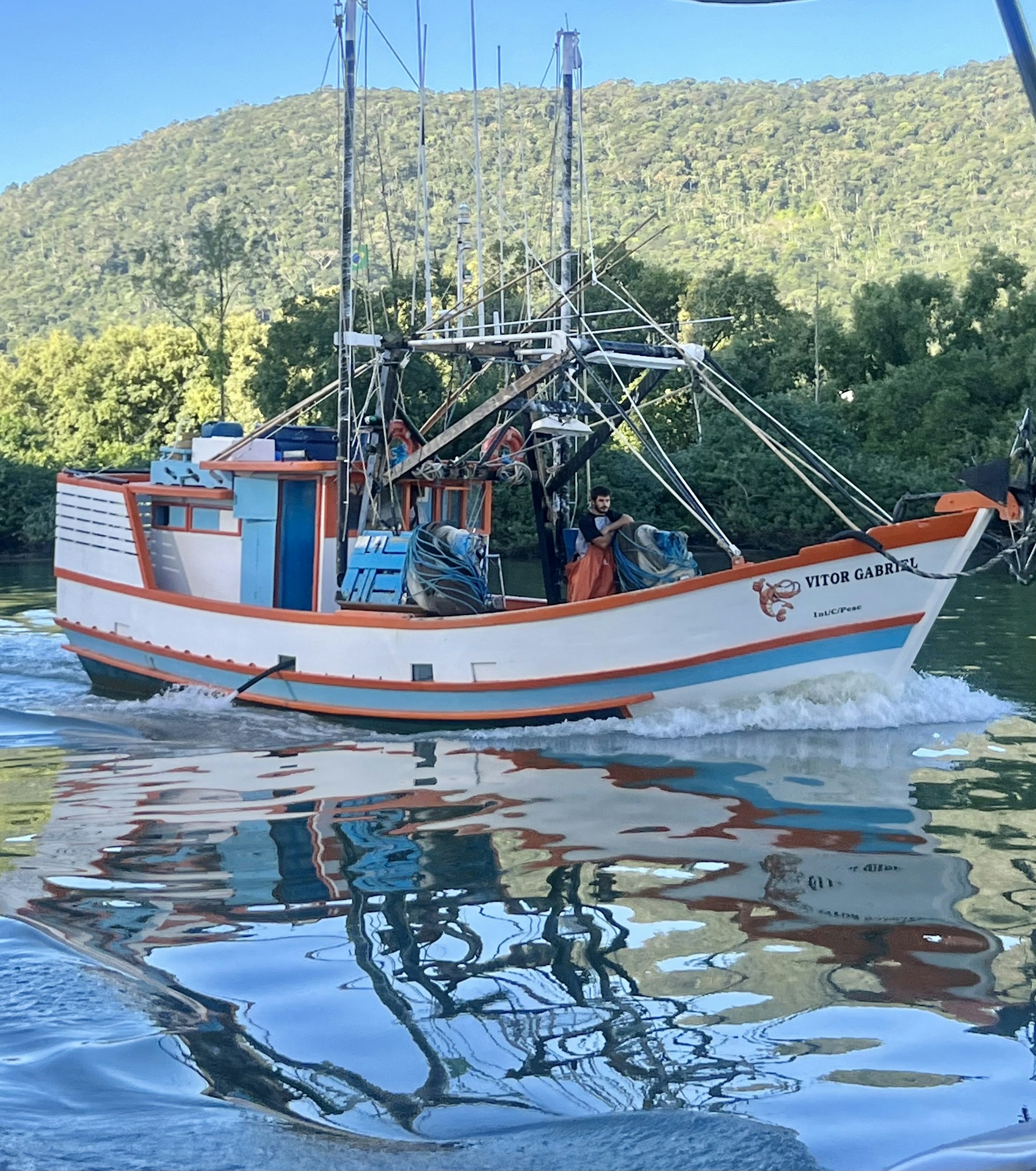 A sleek new fishing boat from Delpasofishing gliding on the calm waters of Paso de la Patria at sunrise.