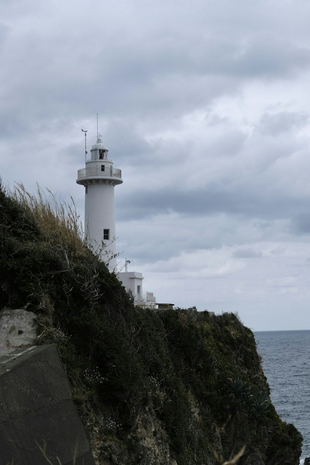 a lighthouse on a cliff overlooking the ocean