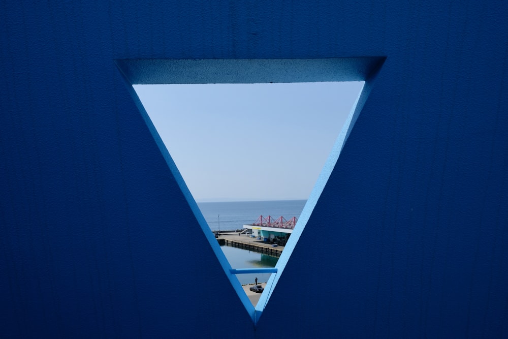 a view of a body of water through a blue door