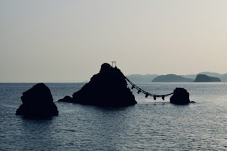 a rock formation in the middle of a body of water