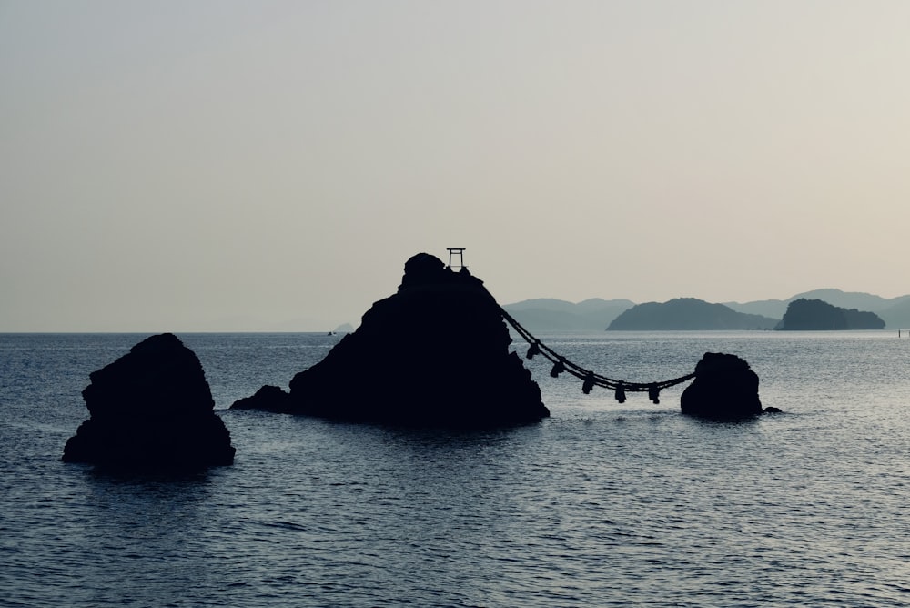 a rock formation in the middle of a body of water