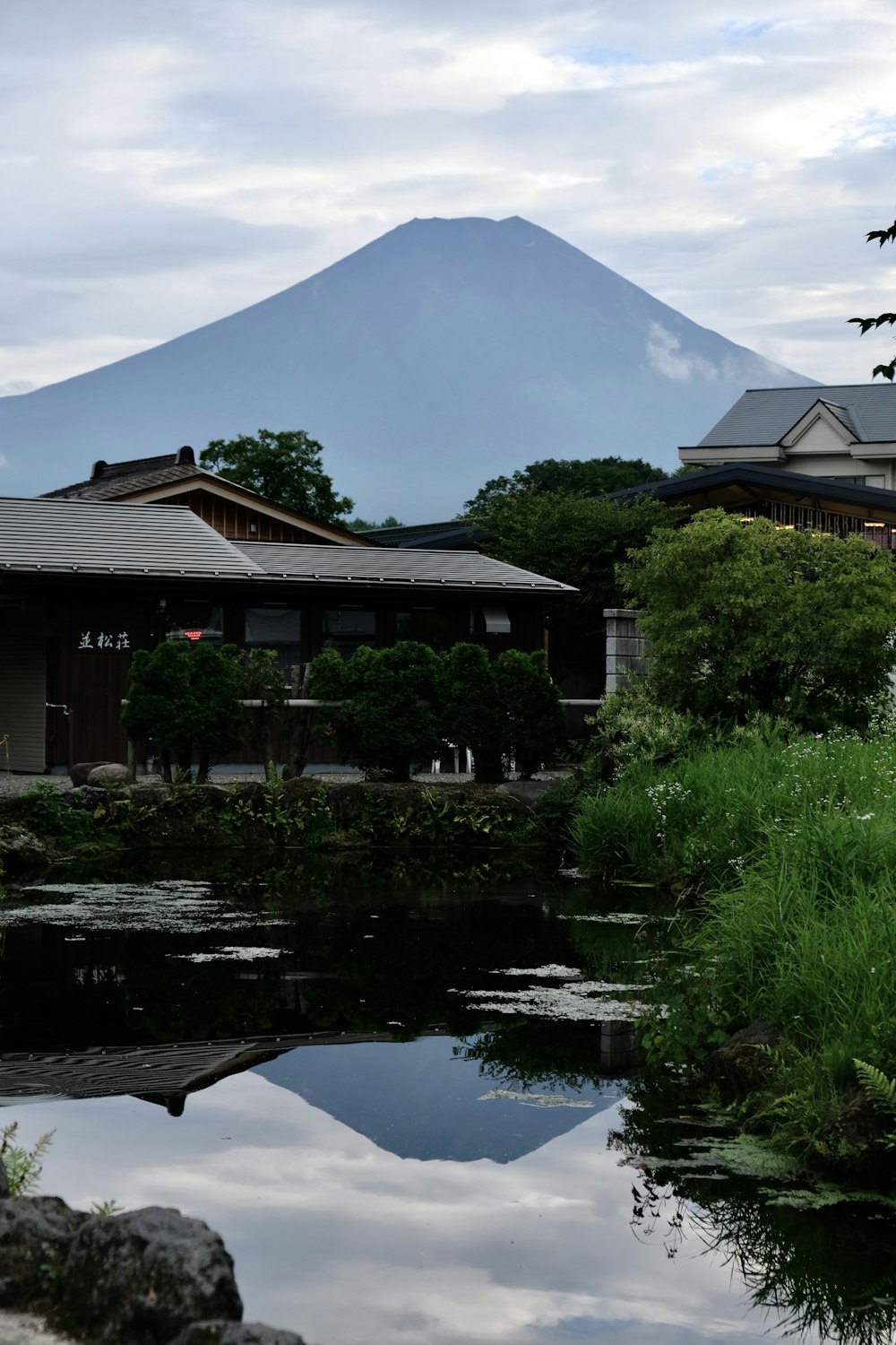 a mountain is reflected in the water of a pond