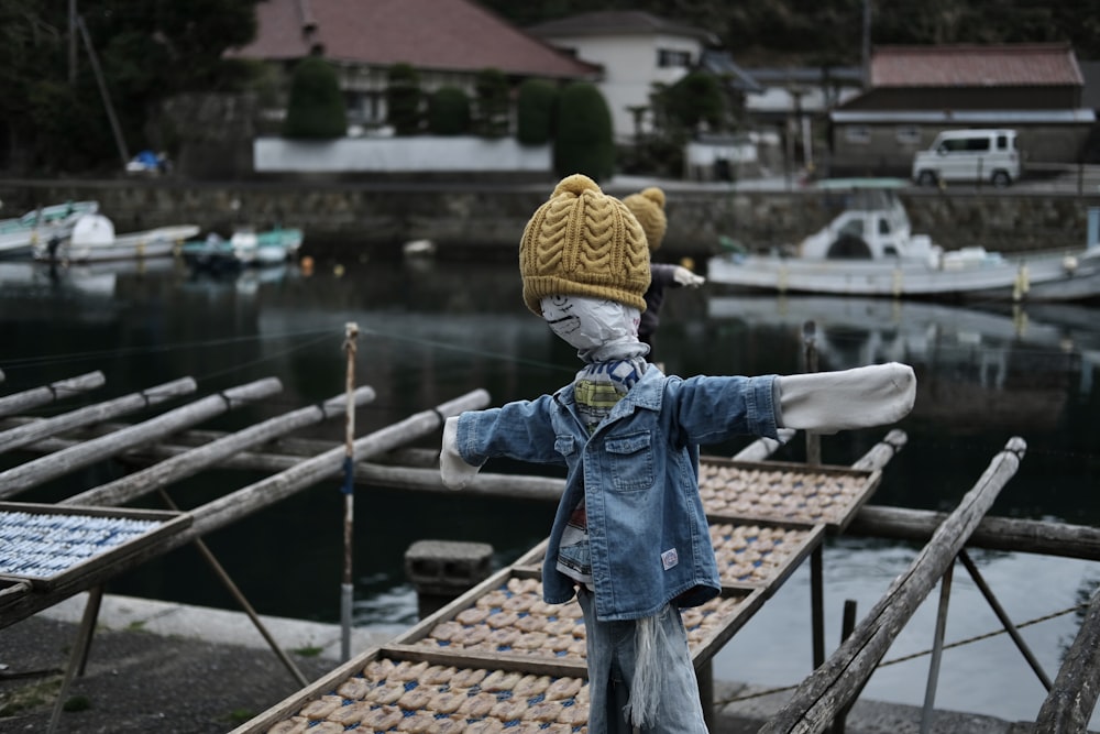 a stuffed animal is standing on a dock