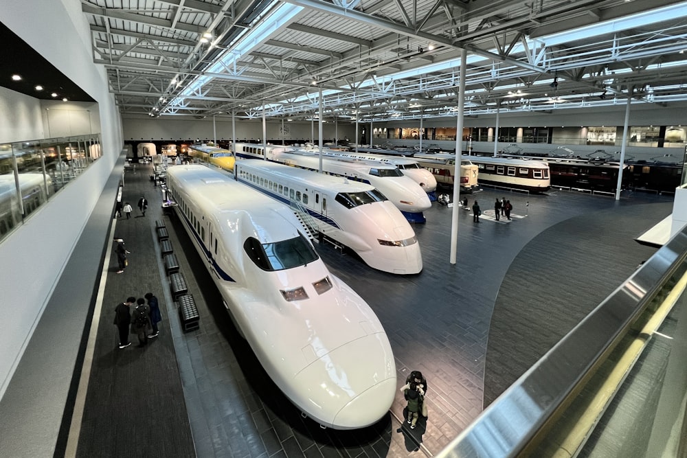 a couple of trains that are in a building